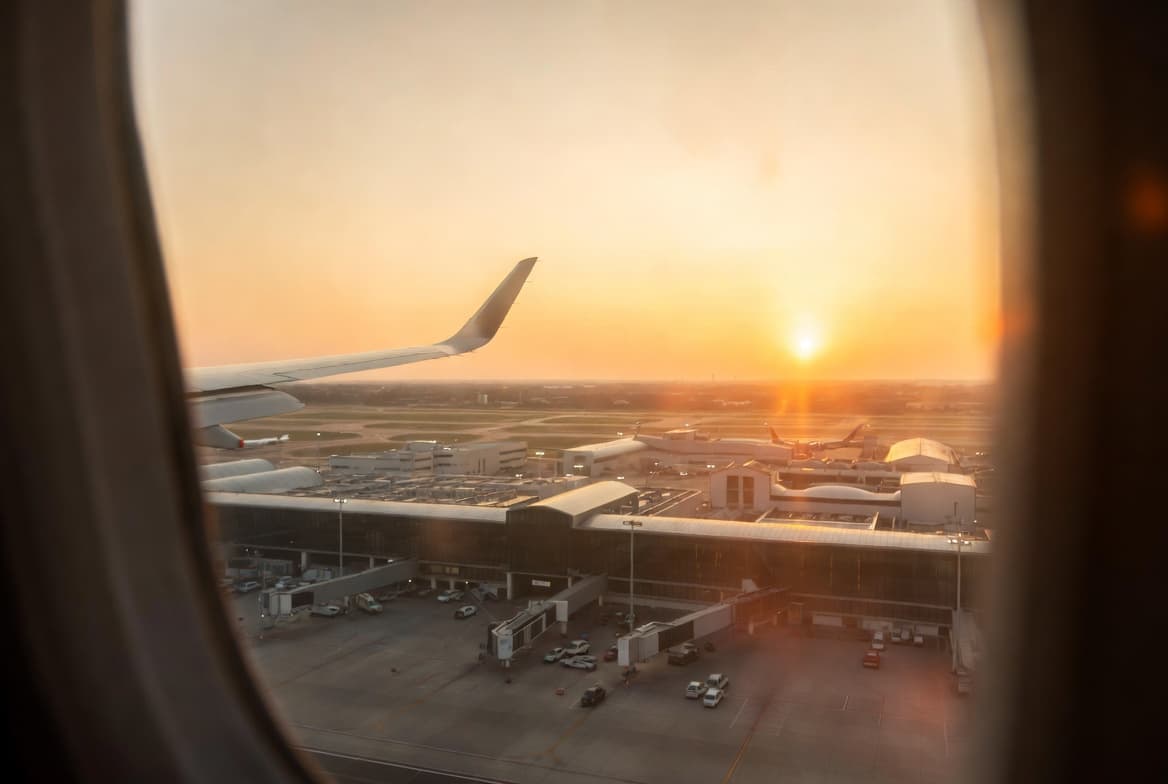 A traveler's view of an airport from an airplane window