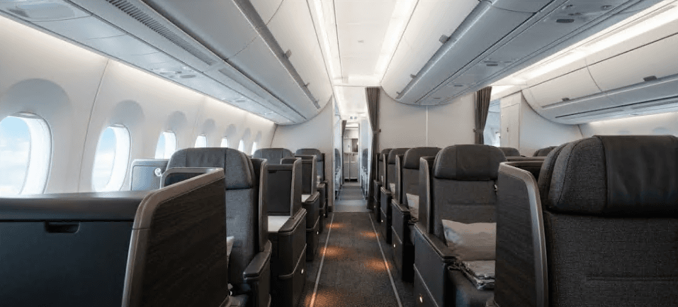The interior aisle of an aircraft cabin.
